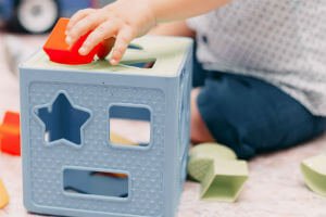 child playing with toy blocks