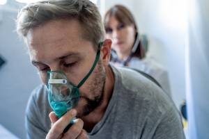 man with mask over nose to help him to breathe