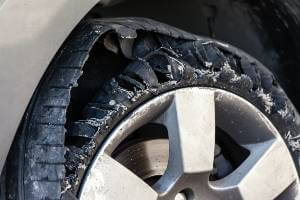 ripped up tire on car