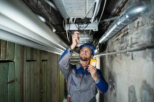 electrician under pipes