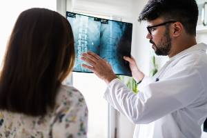 doctor reviewing spinal cord x-ray