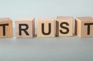 trust in black letters on wooden blocks