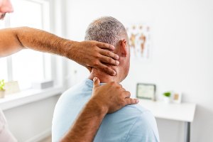 doctor adjusting patient's neck