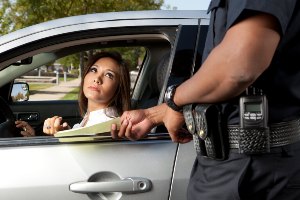 handing paper ticket to female driver