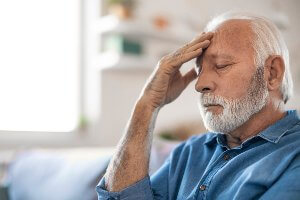 older man with serious headache