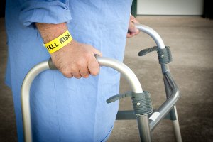 old person with walker and fall risk bracelet