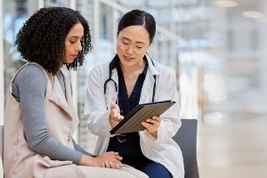 A health care professional talking to a woman.